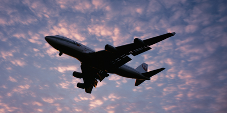 Boeing 747 airplane in flight against evening clouds