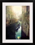 Two gondolas floating in water surrounded by old buildings.