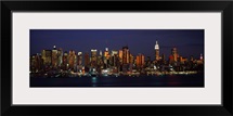 Skyscrapers lit up at night in a city, Manhattan, New York City, New York State