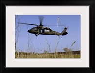 A US Army UH60 Black Hawk helicopter prepares to pick up soldiers