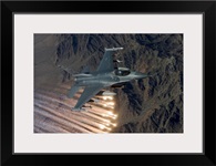 An F-16 Fighting Falcon releases flares during a training mission
