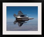An F-22 Raptor maneuvers while flying a training mission over New Mexico