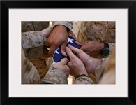 Marines fold an American flag