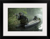 Navy SEALs navigate the waters in a folding kayak during jungle warfare operations