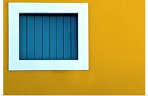 Window on yellow wall.