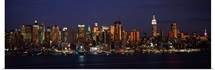 Skyscrapers lit up at night in a city, Manhattan, New York City, New York State