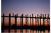 People walking on Ubein Bridge at Sunset, Mandalay, Burma