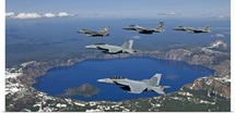 A five-ship aircraft formation flies over Crater Lake, Oregon