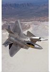 Two F-22 Raptors maneuver while on a training mission over New Mexico