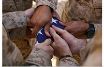 Marines fold an American flag