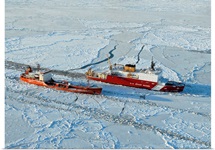 USCG Healy breaks ice around a Russian-flagged tanker south of Nome, Alaska