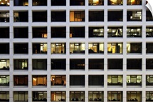 Working later night in office building in financial district of Hong Kong.