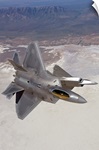 Two F-22 Raptors maneuver while on a training mission over New Mexico