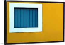 Window on yellow wall.