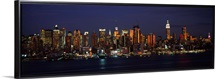 Skyscrapers lit up at night in a city, Manhattan, New York City, New York State