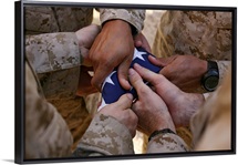 Marines fold an American flag