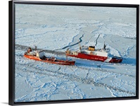 USCG Healy breaks ice around a Russian-flagged tanker south of Nome, Alaska