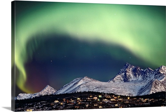 Aurora Borealis over hillside neighborhood & Chugach Mountains Anchorage Alaska