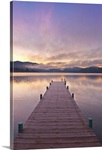 Footprints leading down a frost covered dock at sunrise on Lake Whatcom during Winter