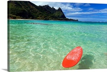 Hawaii, Kauai, Haena Beach, Red Surfboard Floating In Shallow Ocean
