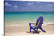 Plumeria Lei Hanging Over Blue Beach Chair Along Shoreline