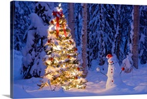 Snowman with santa hat hanging ornaments on a  Christmas tree