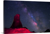 Alabama Hills, rock tower painted with red light with stars and Milky way in sky