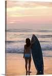 Asian girl holding surfboard at beach
