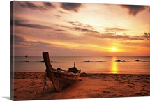Boat on beach at sunset on Koh Lanta, Thailand.