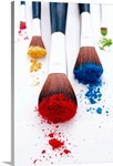Brightly coloured eyeshadow powders on eyeshadow brushes, close-up