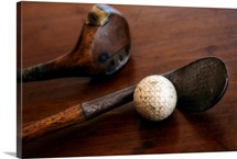 Close up of antique golf clubs and golf ball