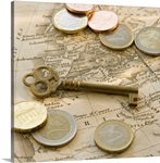Close up of Euro coins, map and antique key