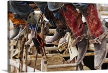 Cowboys sitting on a cattle stall