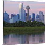 Dallas skyline reflected in water at sunset.