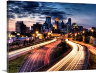 Downtown Minneapolis skyline and light trails on road