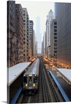 Elevated rail in downtown Chicago over Wabash and Trump Tower in background.