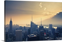 Empire State Building and airplane flying into clouds.