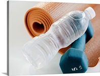 Exercise mat, water bottle and weights, studio shot