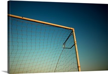 Football (Soccer) Goalpost and net against blue sky.