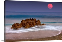 Full moon over ocean and rocks, Florida.
