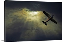Image of an airplane flying over sunset sky.