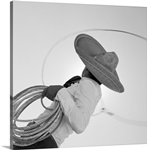 Man wearing hat and holding lasso