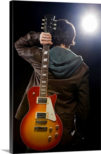 Man with guitar in spotlight