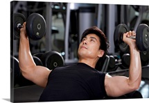 Mid-Adult Man Lifting Weights