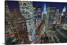NYC skyscrapers light up by night, New York.