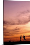 Silhouette of runners at sunset