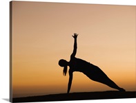 Silhouette of woman doing yoga