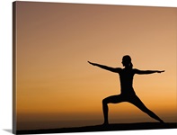 Silhouette of woman doing yoga