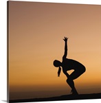 Silhouette of woman doing yoga