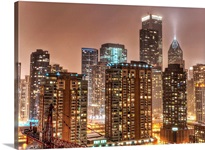 Snow falls over skyline at evening in Chicago.